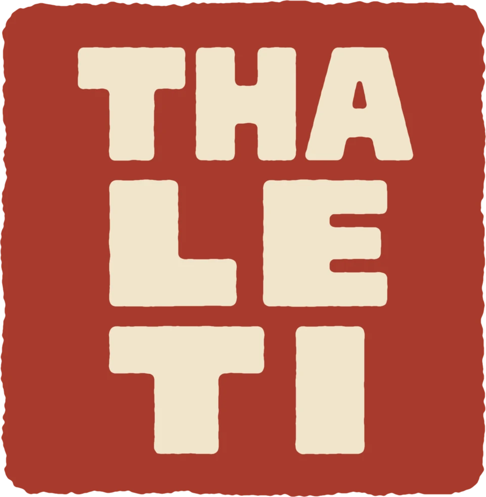 The Thaleti Games seal: THA, LE and TI stacked in cream letters on a red square
